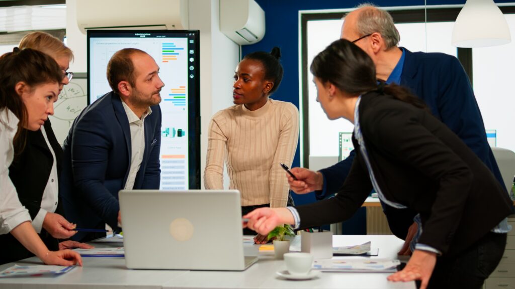International business team talking to african woman mentor
